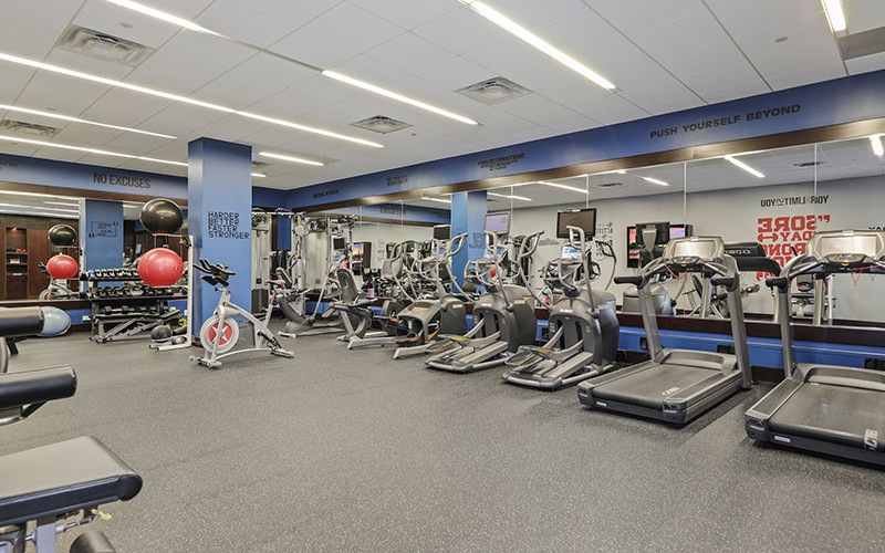 Large fitness center with cardio and weight lifting equipment.